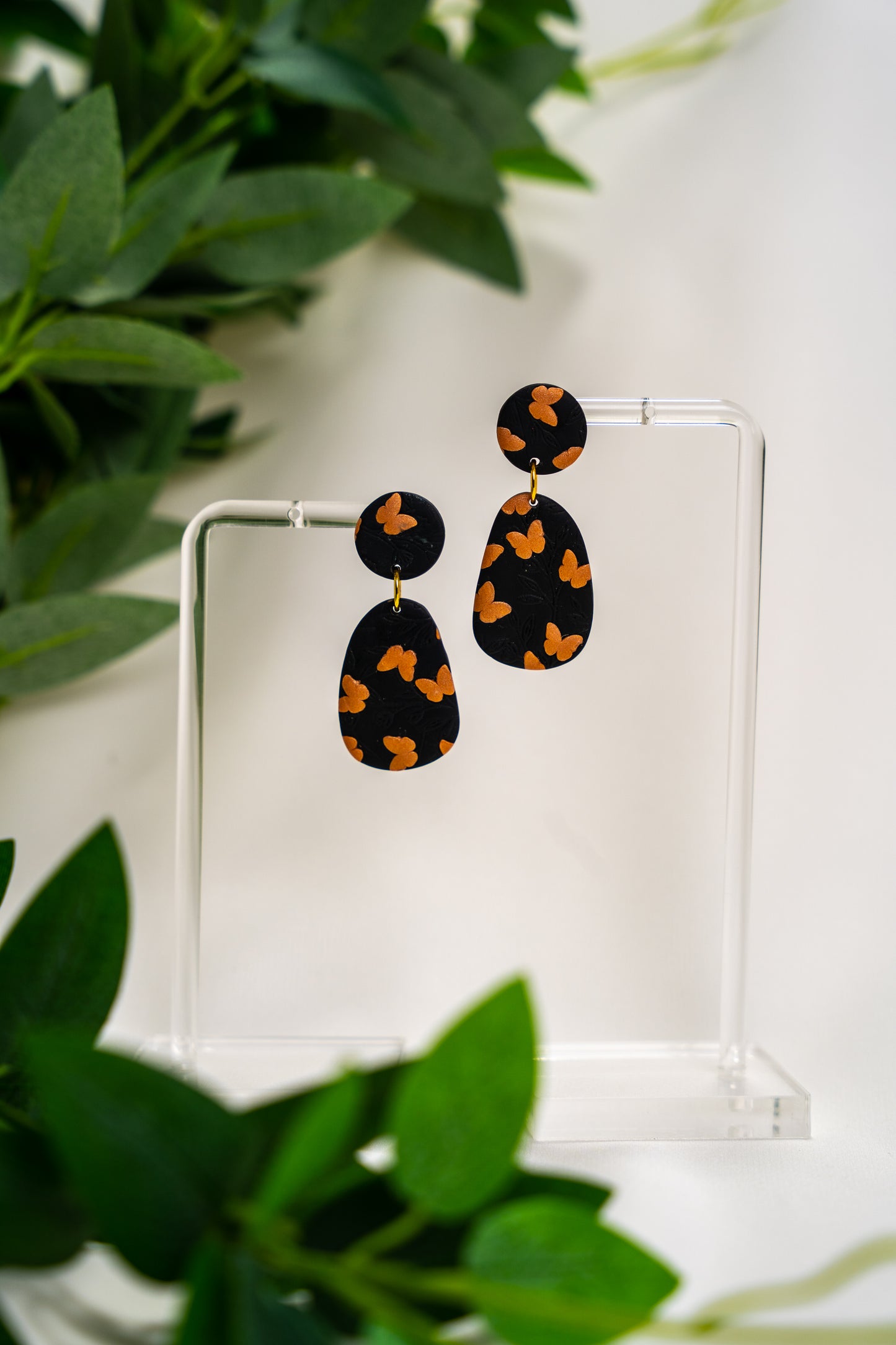 Black oval dangles with copper coloured butterflies