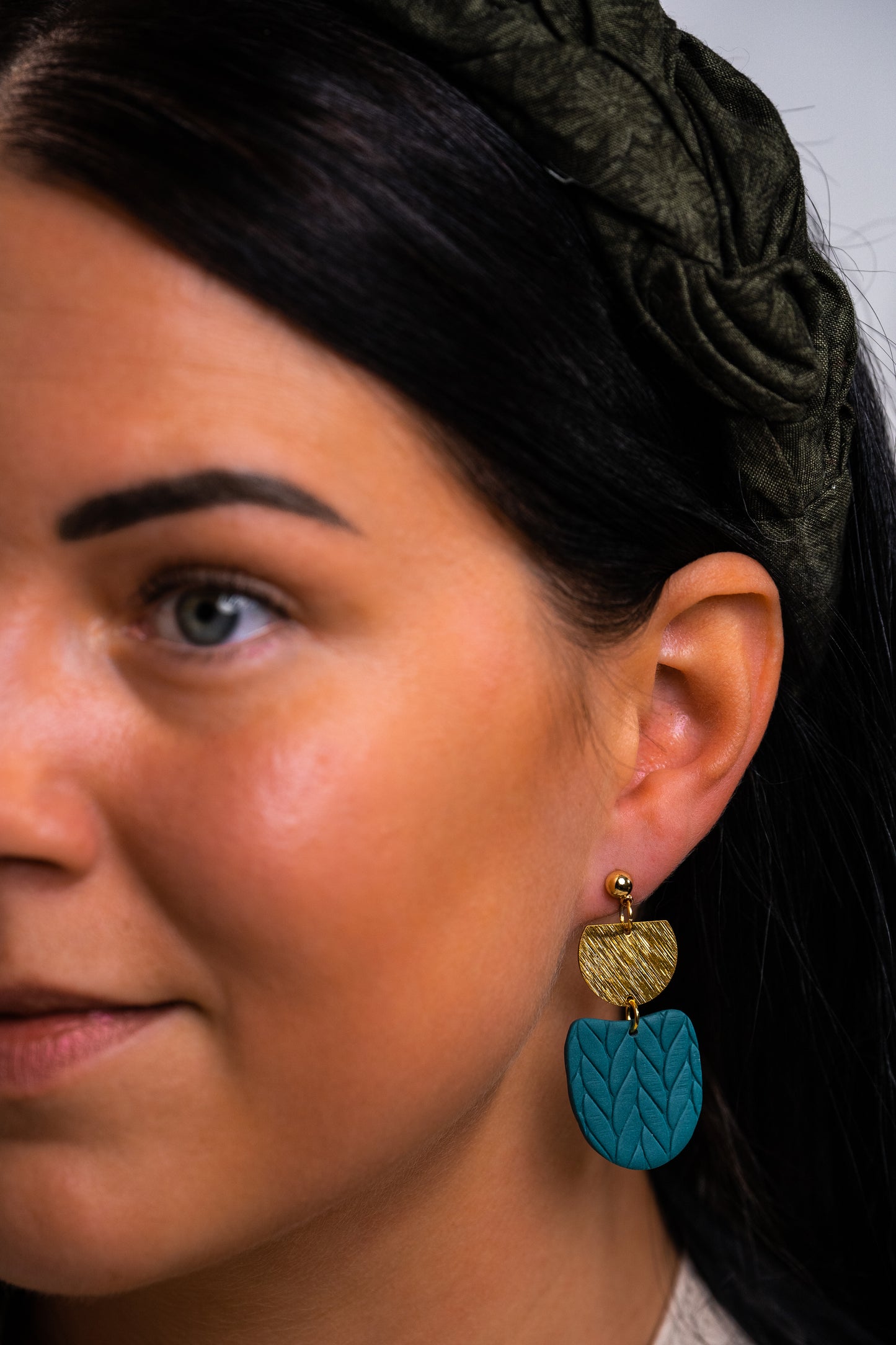 Teal embossed knitted dangles with round gold detail